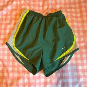 Nike Dri-Fit shorts in aqua green, light yellow, and white